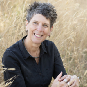 Image a woman sitting in long grass.