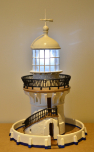 Replica of a lighthouse with a spiral staircase wrapping around the front.