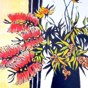 Detail of red blossoms of cut banksia in a blue vase.