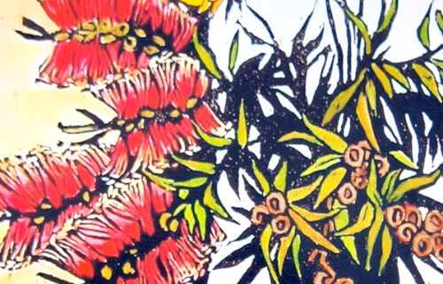 Detail of red blossoms of cut banksia in a blue vase.