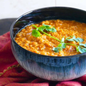 Blue bowl of lentils with coriander on top