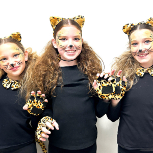 Three girls in lion costumes
