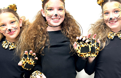 Three girls in lion costumes