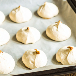 A tray of meringues with slighly browned tips