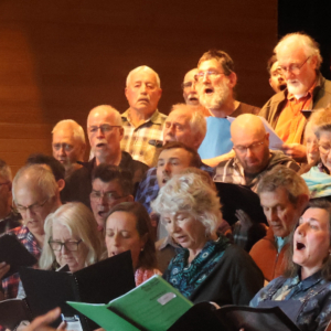 A group of people in a choir singing