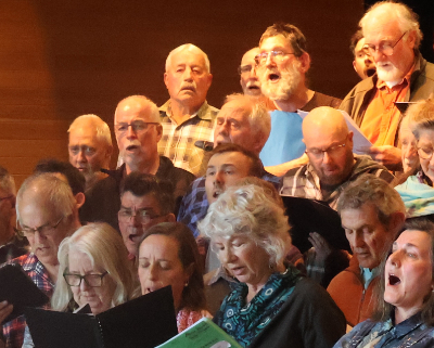 A group of people in a choir singing