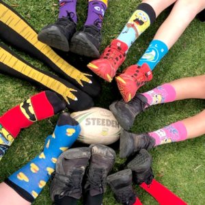 Seven pairs of feet with fancy socks