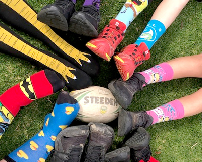 Seven pairs of feet with fancy socks