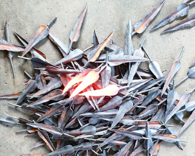 Metal leaves where the ones in the centre are glowing red from heat