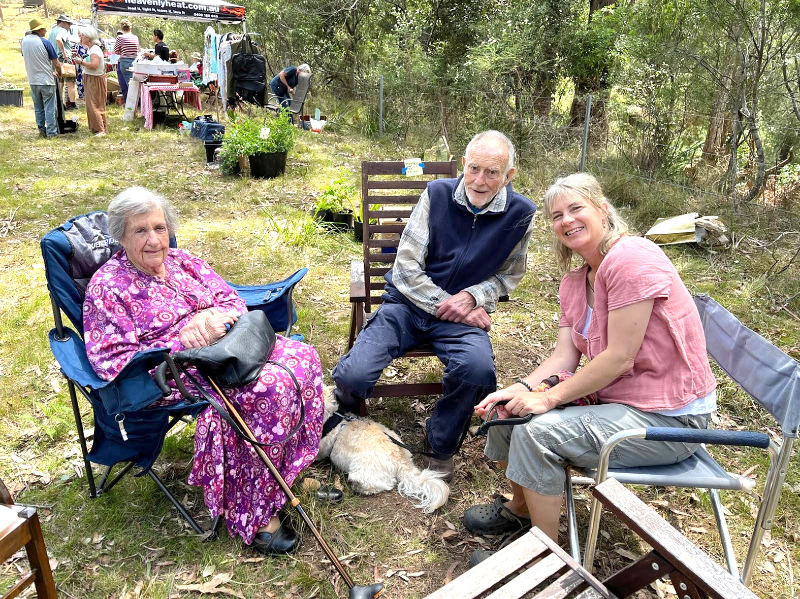 Three people sitting in outdoor chairs
