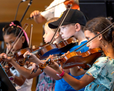 Four young people playing violins