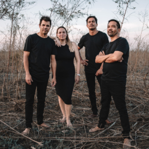 Four musicians dressed in black.