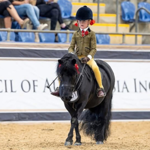 Person riding a pony in competition