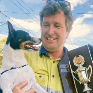 Man with dog and trophy