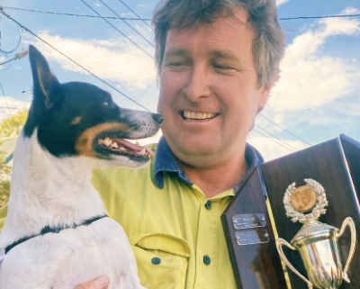 Man with dog and trophy