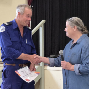 Man in Marine Rescue uniform receiving award