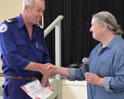 Man in Marine Rescue uniform receiving award