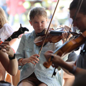 Young buskers playing their violins.