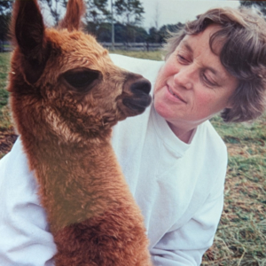 Woman and alpaca face to face