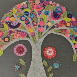 Felt applique of a tree filled with colourful flowers