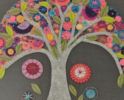 Felt applique of a tree filled with colourful flowers