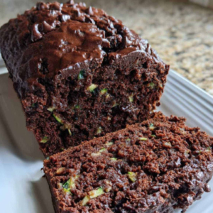 Chocolate cake with green flecks of zucchini in cut slice