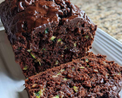 Chocolate cake with green flecks of zucchini in cut slice