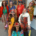 A group of women in wildly colourful costumes and sunglasses