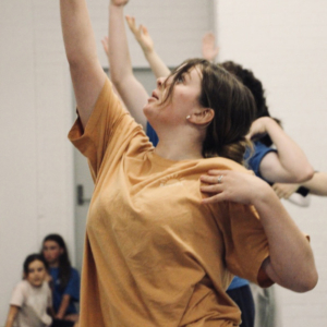 Several women with arms outstretched.