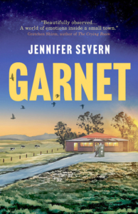 Garnet cover with a painting of petrol station in an Australian landscape.