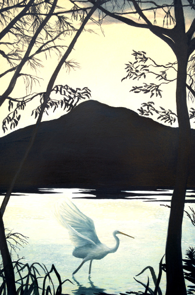 Water bird in the foreground of a lake with mountain silhouette in the background.