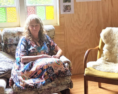 Woman sitting in a chair.
