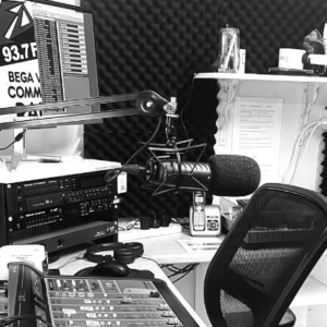 B&W photo of the inside of a radio studio with the mixing deck in the foreground.