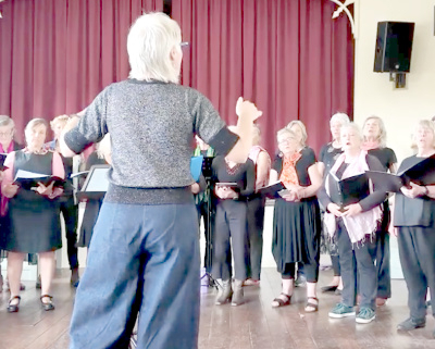 Choir seen from behind the conductor
