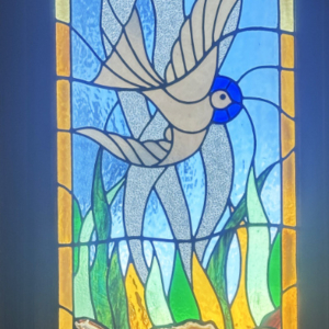 Stained glass depiction of a bird