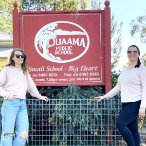 Two women in front of the Quaama Public School sign