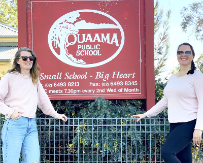 Two women in front of the Quaama Public School sign