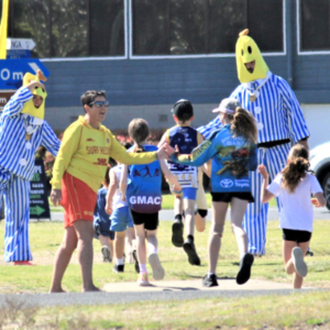 Children on a sports oval with two people dressed as Bananas in Pyjamas
