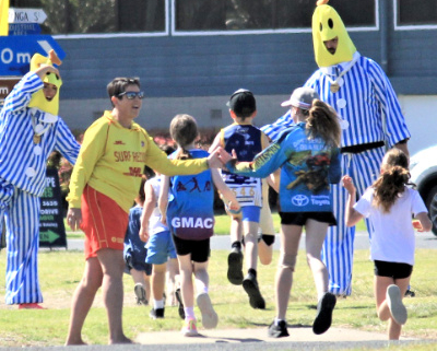 Children on a sports oval with two people dressed as Bananas in Pyjamas