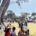Large open space with people and marquees in the background