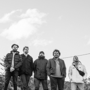 Five men with a huge sky behind them