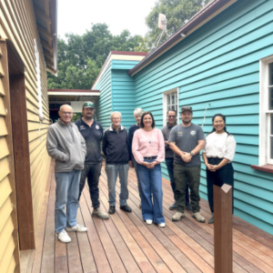 Group of people standing between two buildings.